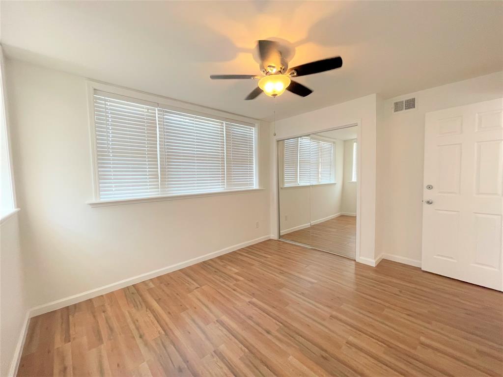 2309 Wesley Street, Unit B Greenville, TX 75401 - Photo 14 of 27 a view of an empty room with wooden floor and a window