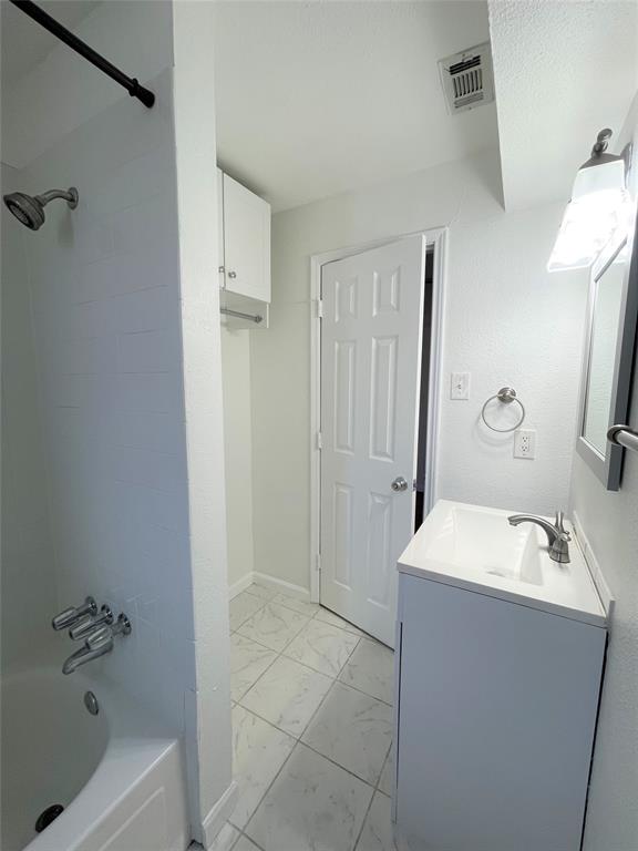 2309 Wesley Street, Unit B Greenville, TX 75401 - Photo 18 of 27 a bathroom with a sink a shower and a mirror