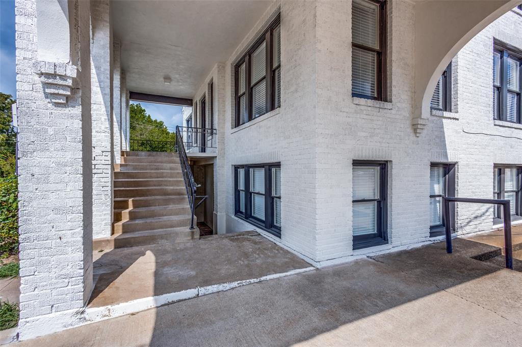 2309 Wesley Street, Unit B Greenville, TX 75401 - Photo 2 of 27 a view of a brick house with many windows