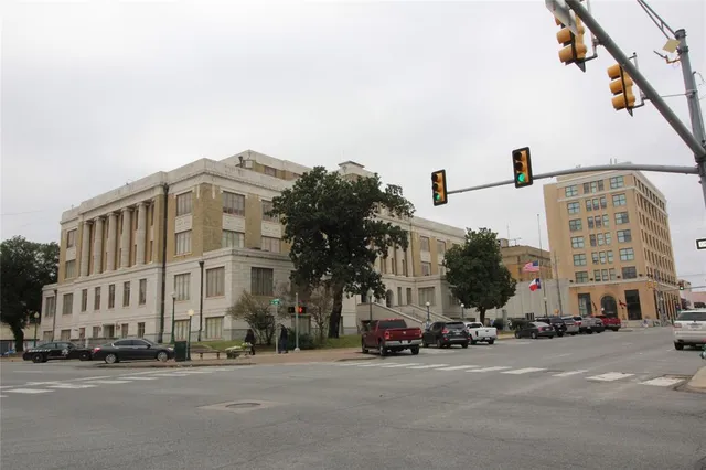 a city street lined with buildings and cars