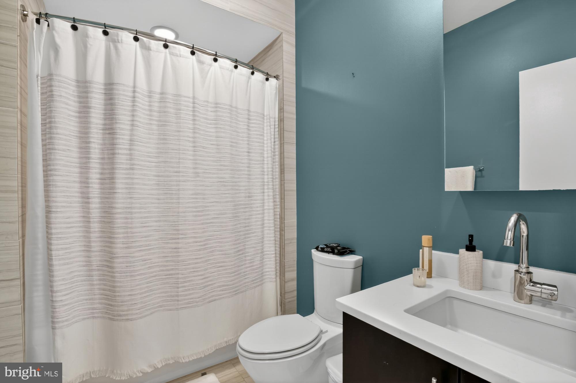 151 North 2nd Street, Unit 5 Philadelphia, PA 19106 - Photo 16 of 35 a bathroom with a sink a toilet and shower curtain