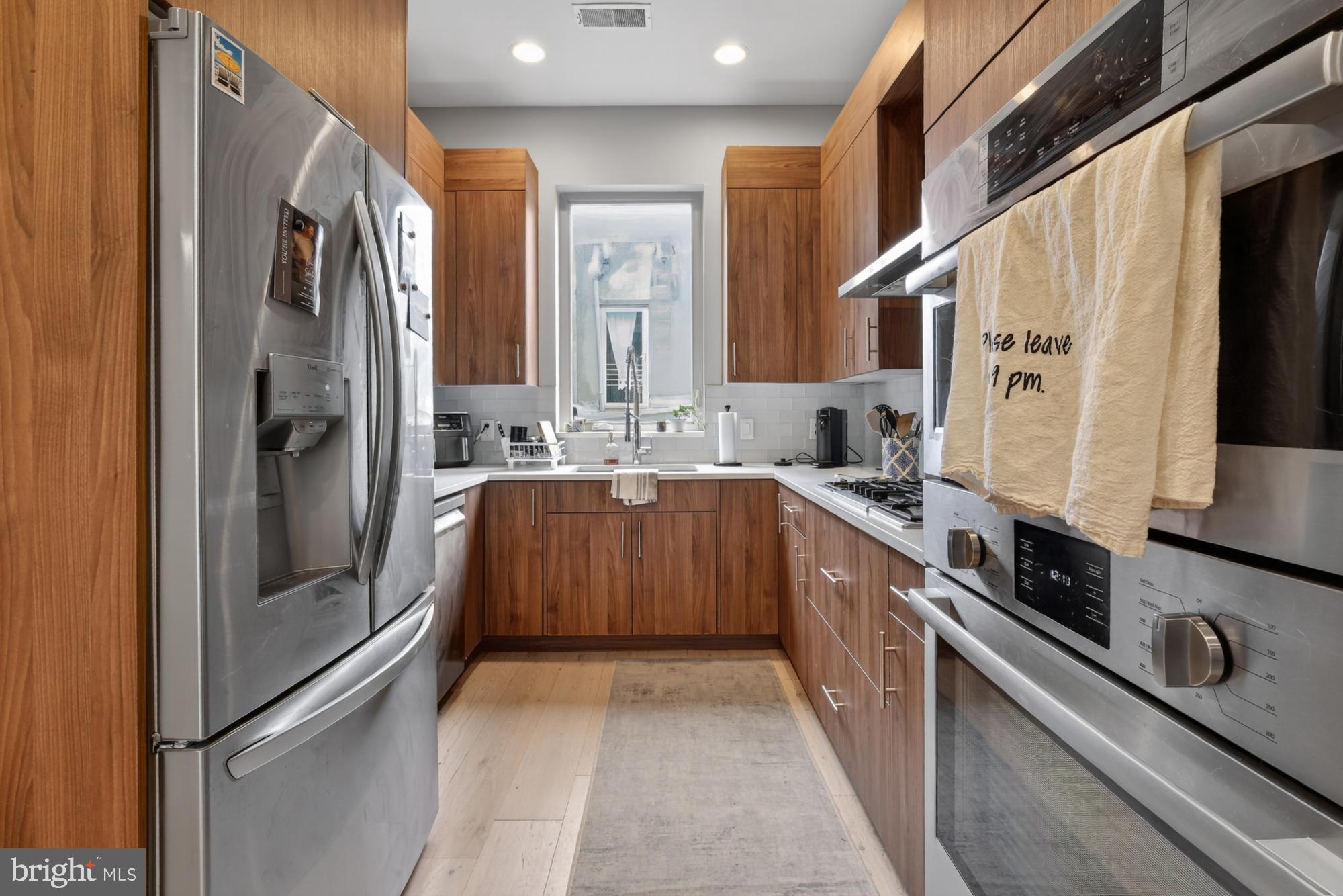 151 North 2nd Street, Unit 5 Philadelphia, PA 19106 - Photo 6 of 35 a kitchen with stainless steel appliances granite countertop a refrigerator a stove and a sink