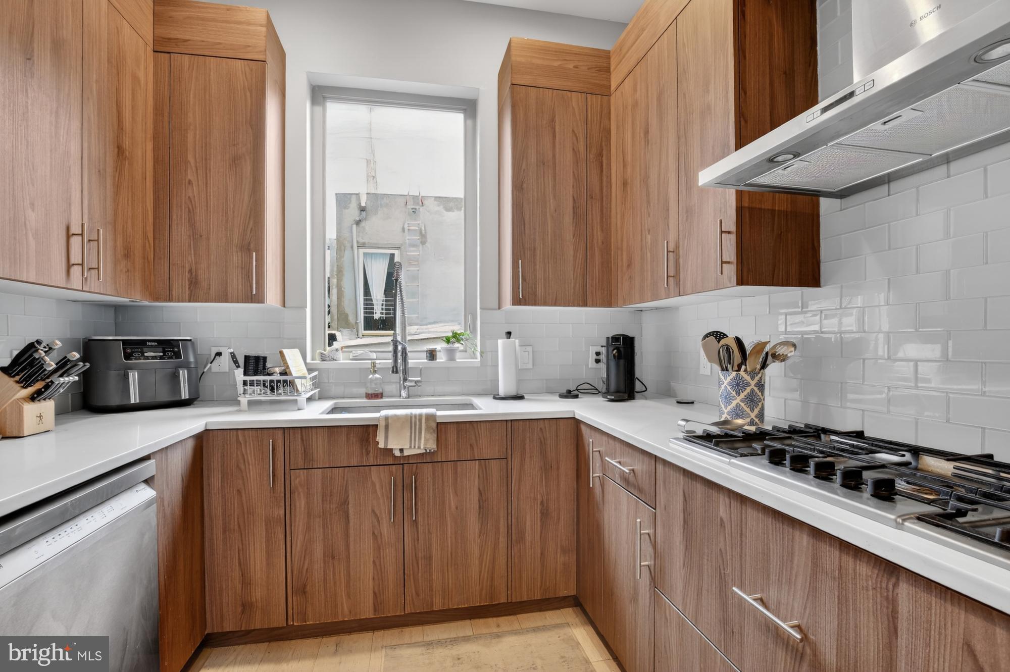 151 North 2nd Street, Unit 5 Philadelphia, PA 19106 - Photo 7 of 35 a kitchen with a sink stove top oven and cabinets