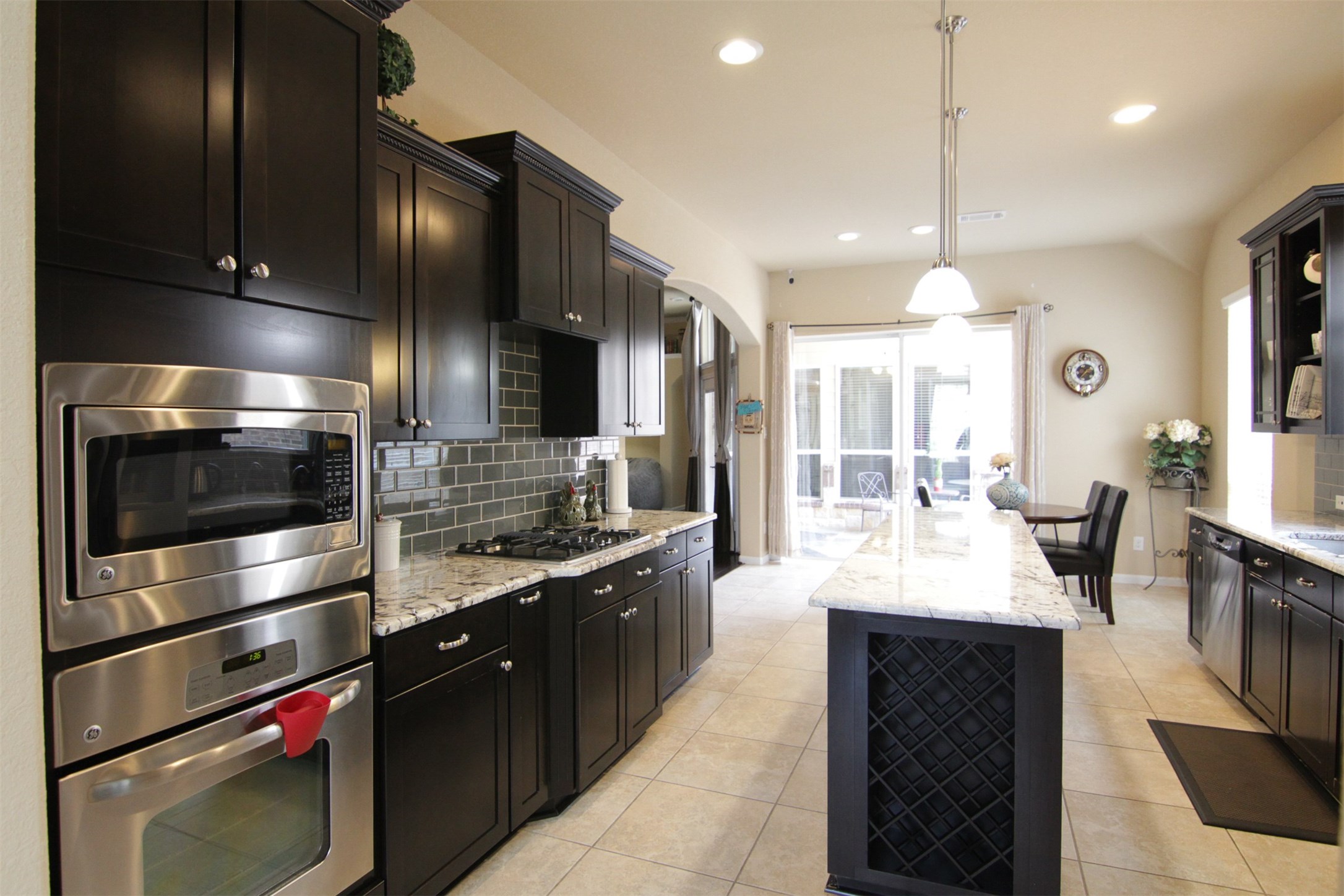 1423 Ralston Branch Way Sugar Land, TX 77479 - Photo 13 of 43 built-in stainless-steel appliances, including countertop microwave in 2025 (not shown), gas oven & cooktop, dishwasher, refrigerator; wine racks; built-in microwave no longer works