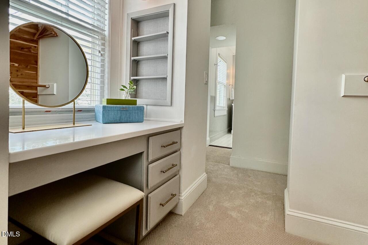 116 Hillcrest Road Raleigh, NC 27605 - Photo 18 of 34 a hallway with a cabinet and a mirror