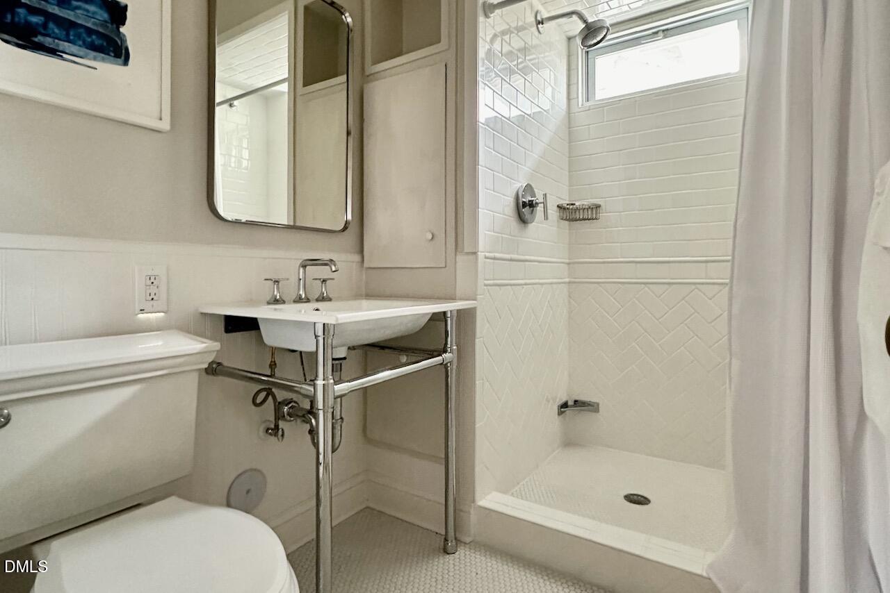 116 Hillcrest Road Raleigh, NC 27605 - Photo 25 of 34 a bathroom with a sink toilet and shower