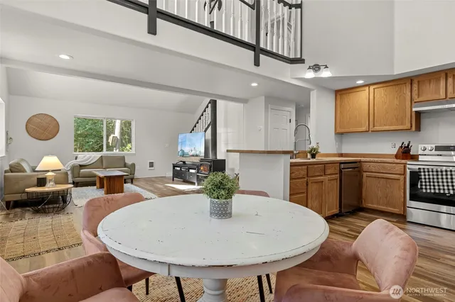 a kitchen with sink a refrigerator and chairs