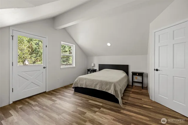 a spacious bedroom with a bed and a window