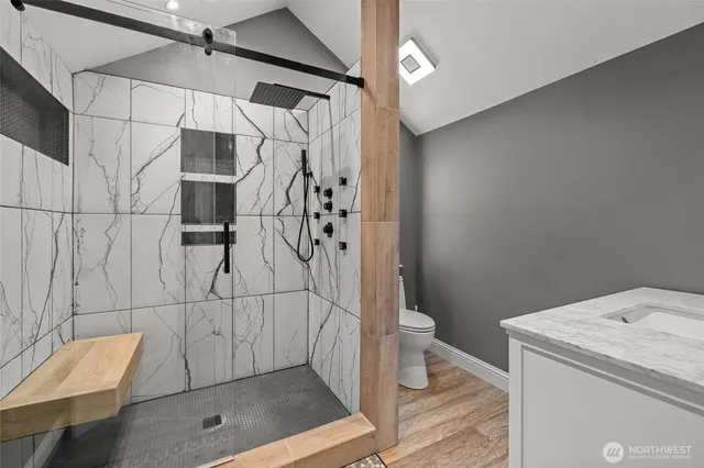a bathroom with a shower and toilet