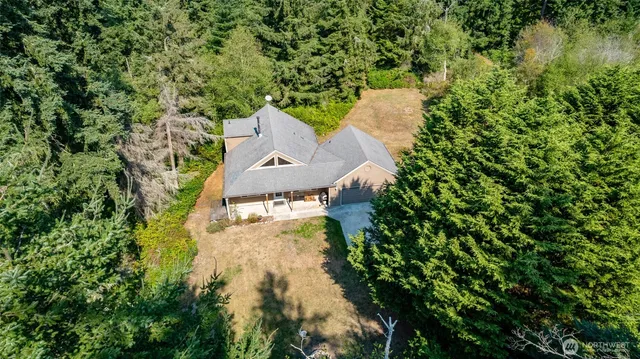 an aerial view of a house with a yard