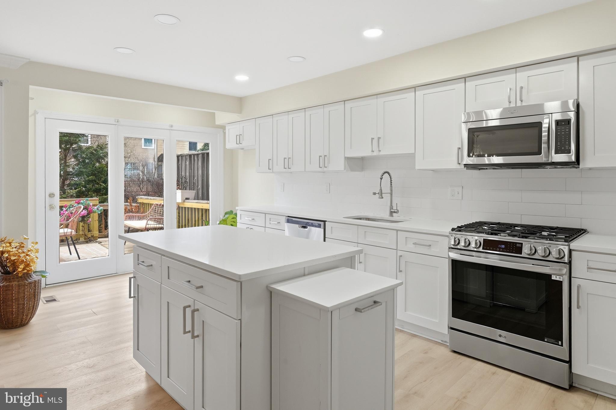 6524 Milva Lane Springfield, VA 22150 - Photo 15 of 47 a kitchen with stainless steel appliances granite countertop a stove a sink and a microwave