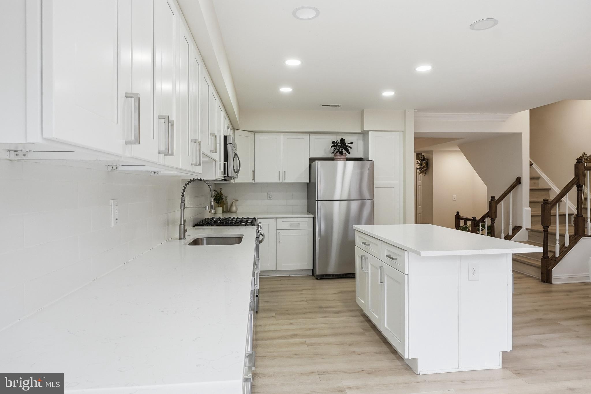 6524 Milva Lane Springfield, VA 22150 - Photo 16 of 47 a kitchen with a sink a refrigerator and cabinets