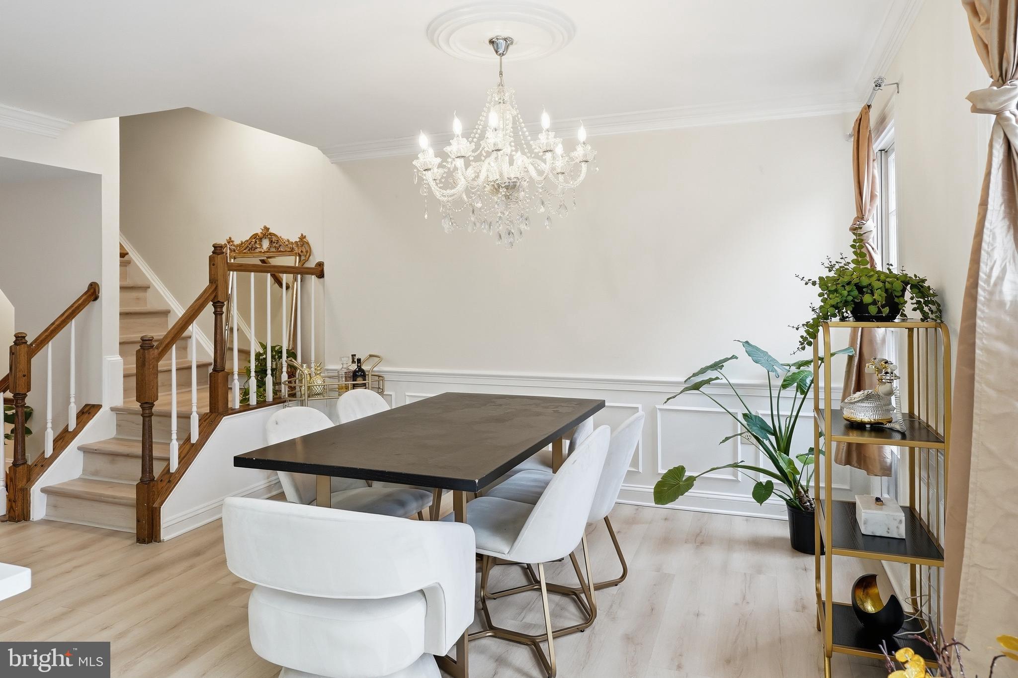 6524 Milva Lane Springfield, VA 22150 - Photo 17 of 47 a living room with a table chairs and a chandelier