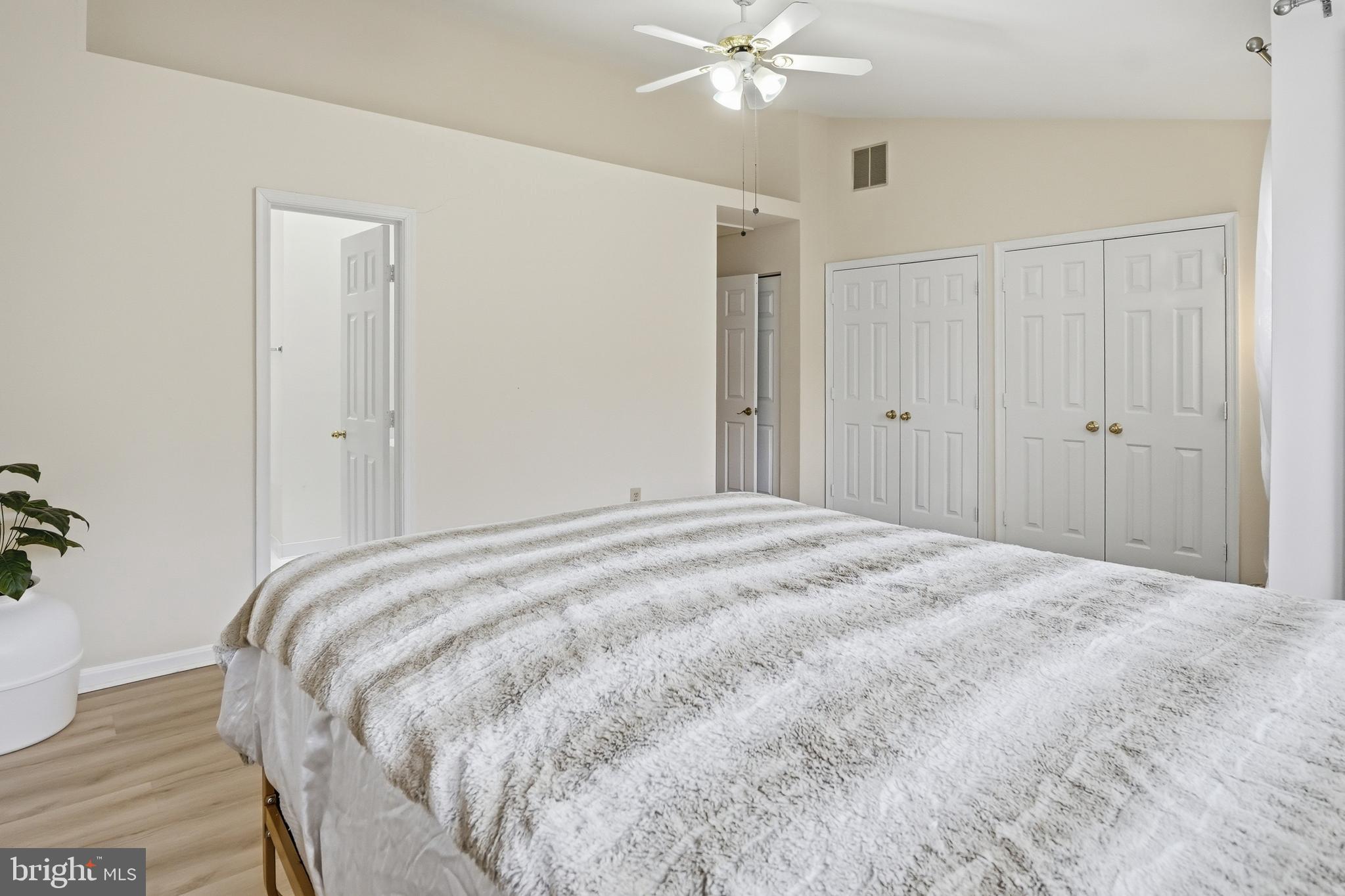 6524 Milva Lane Springfield, VA 22150 - Photo 26 of 47 a bedroom with a bed and a chandelier