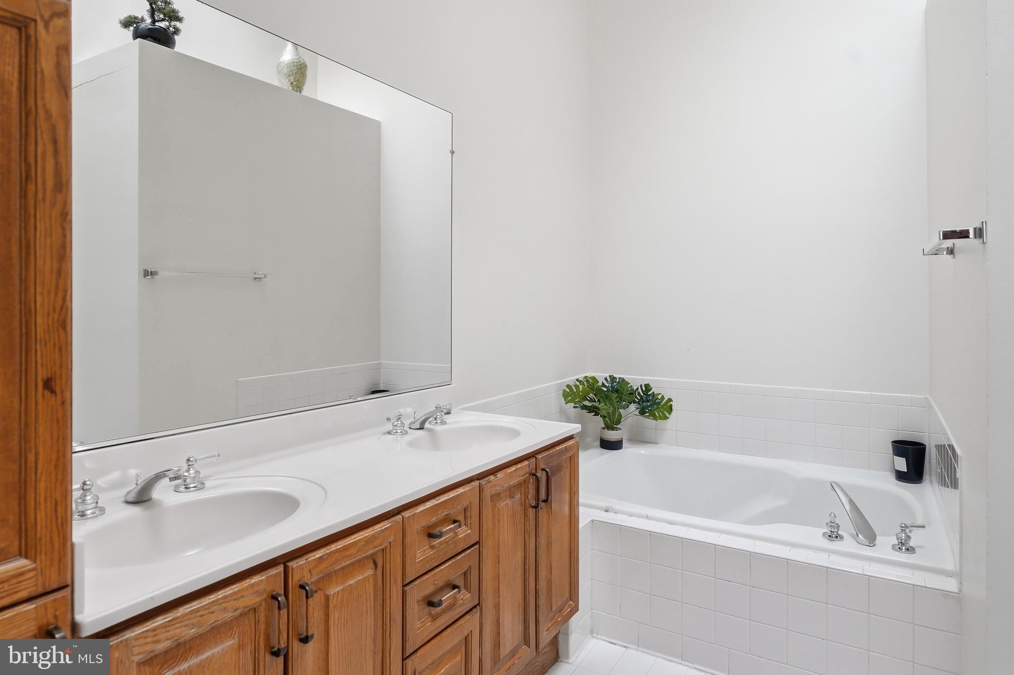 6524 Milva Lane Springfield, VA 22150 - Photo 27 of 47 a bathroom with a tub sink and mirror