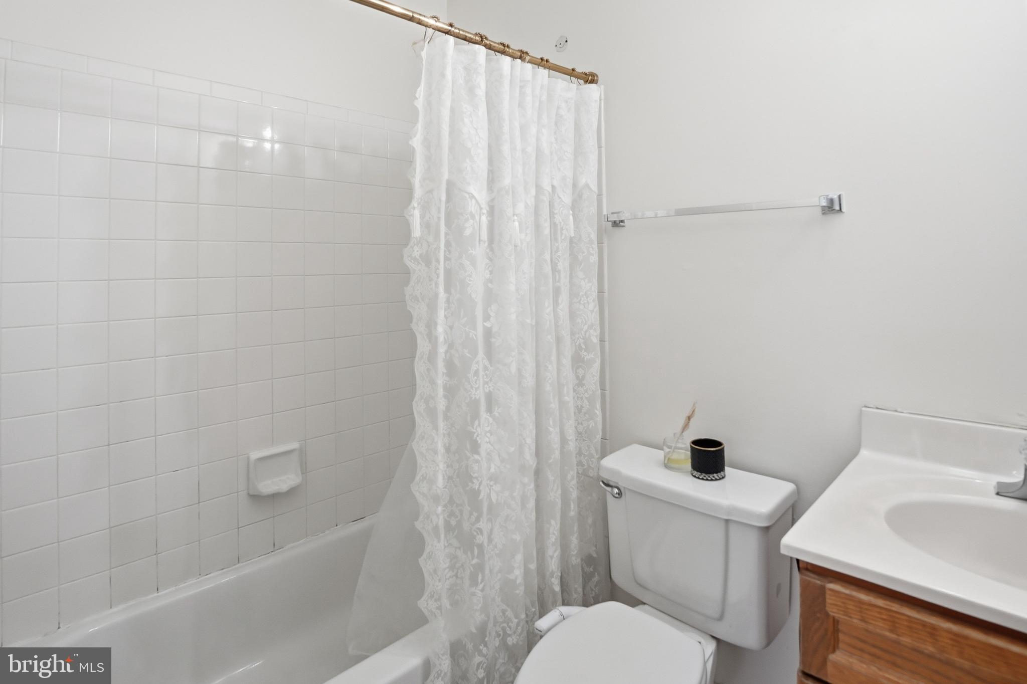 6524 Milva Lane Springfield, VA 22150 - Photo 34 of 47 a white toilet sitting next to a bath tub