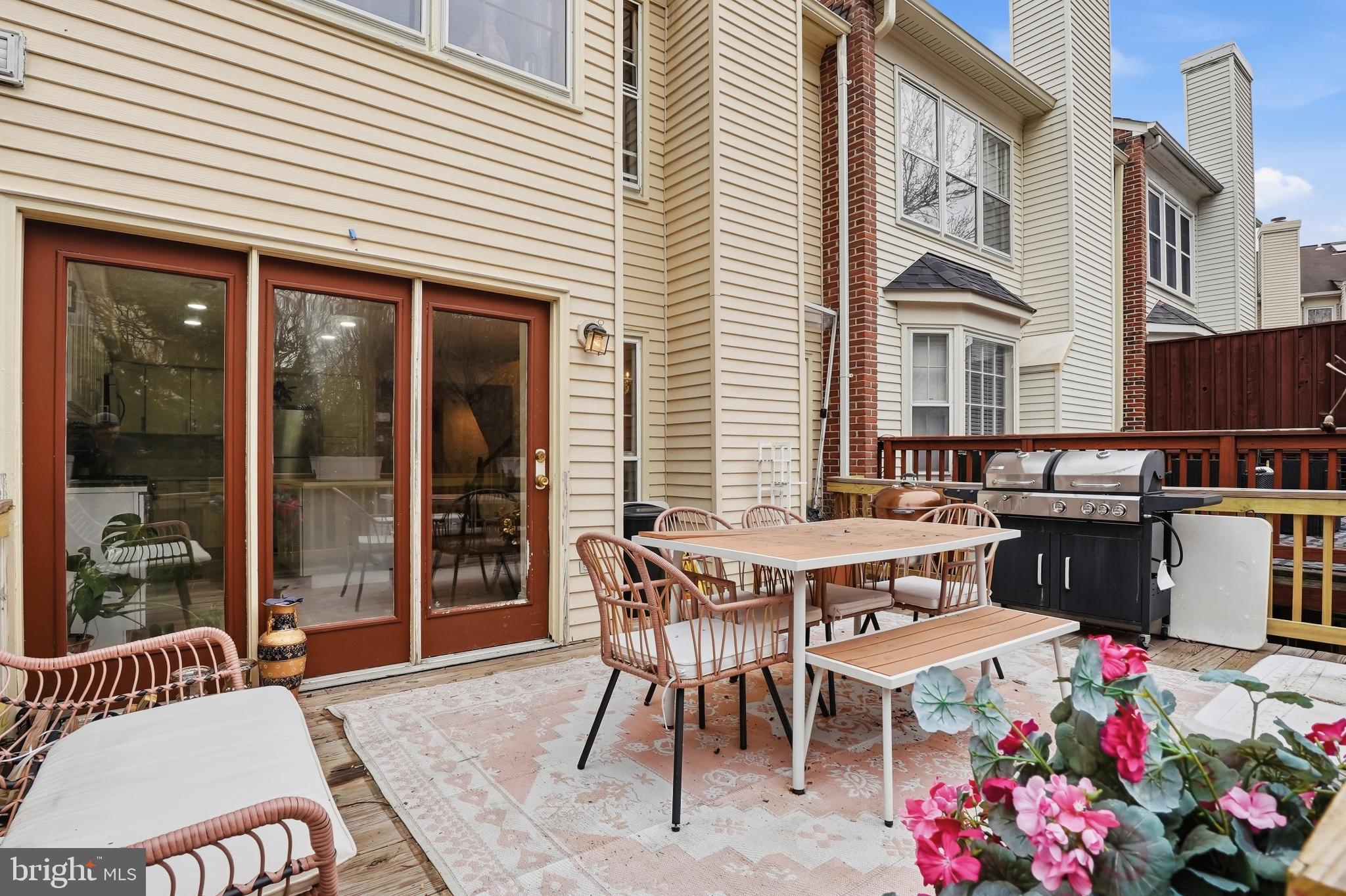 6524 Milva Lane Springfield, VA 22150 - Photo 39 of 47 a view of a patio with a table and chairs and potted plants