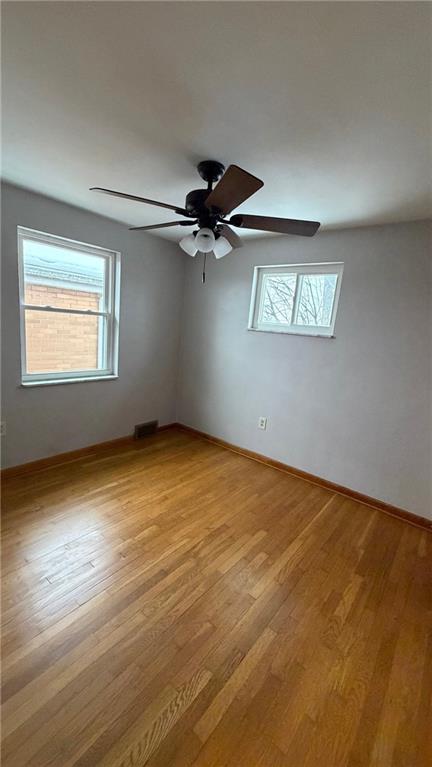 22 Adrian Avenue, Unit 2 Pittsburgh, PA 15229 - Photo 13 of 14 an empty room with a window and a ceiling fan