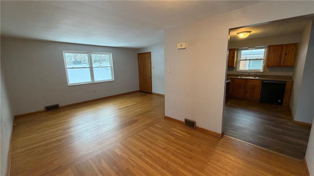 22 Adrian Avenue, Unit 2 Pittsburgh, PA 15229 - Photo 3 of 14 an empty room with wooden floor and windows