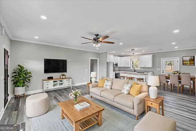 a large kitchen with stainless steel appliances granite countertop a lot of counter space and wooden floors