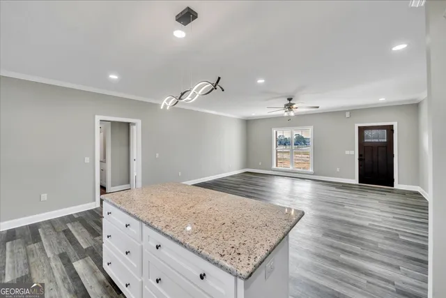 a kitchen with white cabinets stainless steel appliances and a counter space