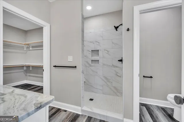 a kitchen with white cabinets and sink