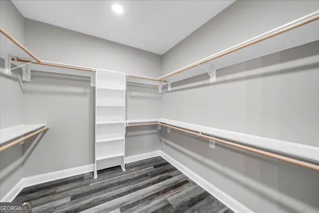 an empty room with window and ceiling fan