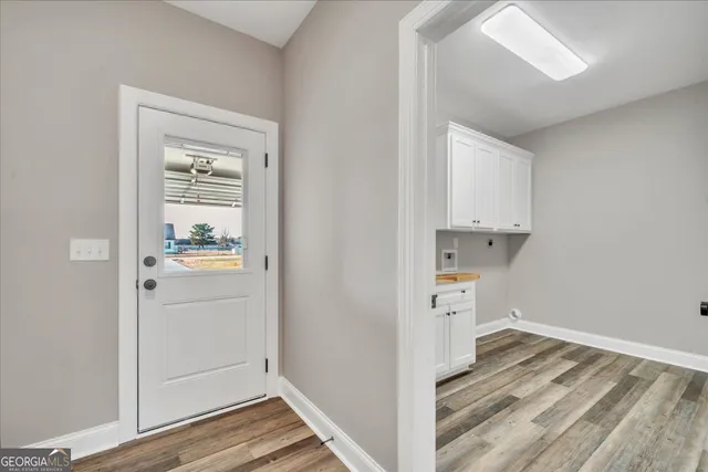 a bedroom with a large bed and a flat screen tv