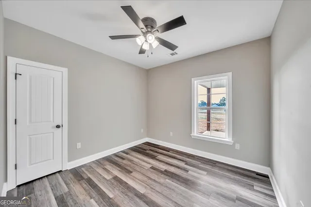 a bedroom with bed and paintings on the wall