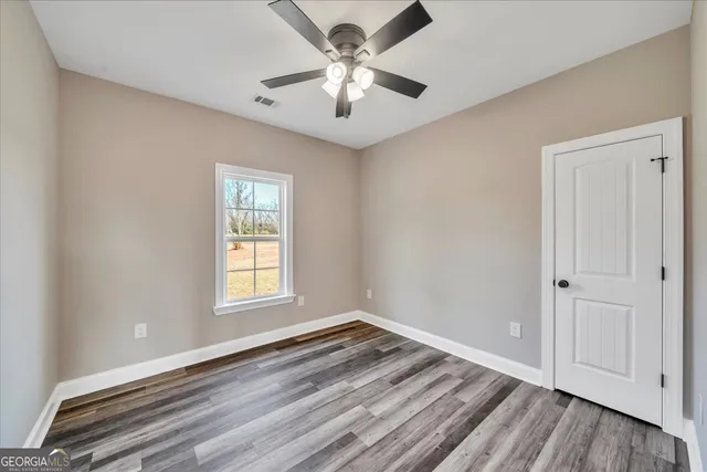 a living room with furniture and a flat screen tv with wooden floor