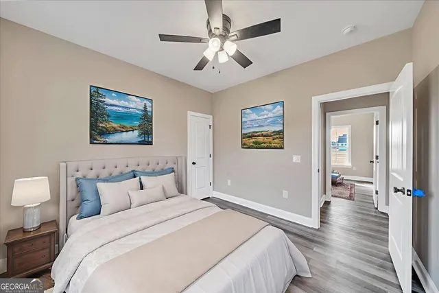 a front view of house with yard and trees in the background