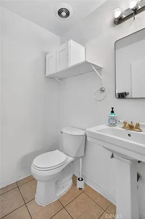 a bathroom with a sink a toilet and vanity