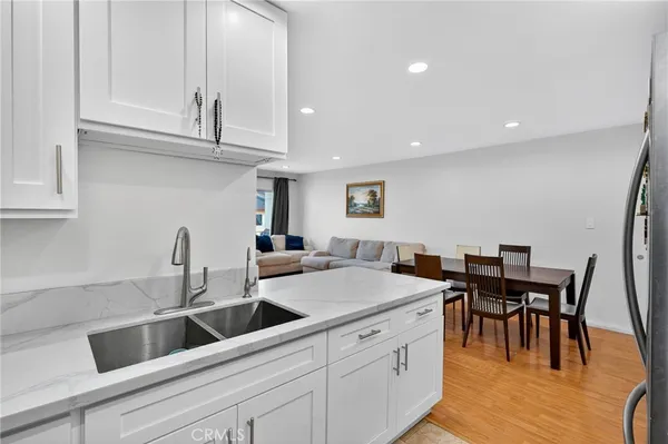 a kitchen with granite countertop a table and chairs