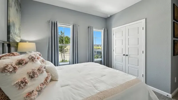 a bedroom with a bed and a window