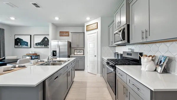 a kitchen with cabinets and refrigerator
