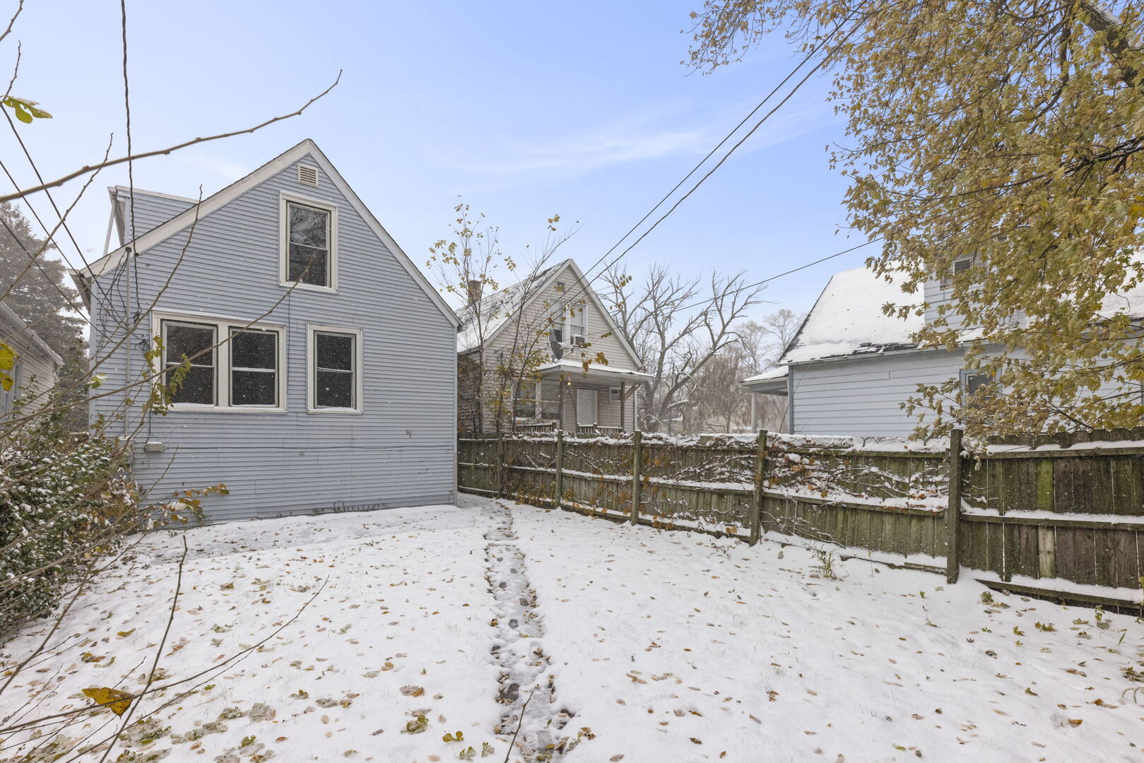 12012 South Michigan Avenue Chicago, IL 60628 - Photo 19 of 24 a front view of a house with a yard covered with snow
