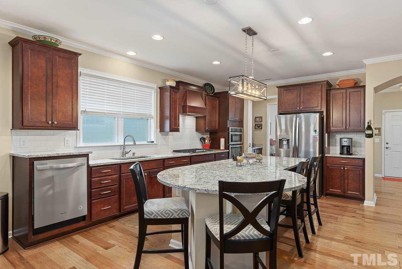 613 Tuttle Road Durham, NC 27703 - Photo 9 of 30 Large countertops offers additional seating. Notice the raised dishwasher that makes for easy loading. No more stopping down to reach the back!