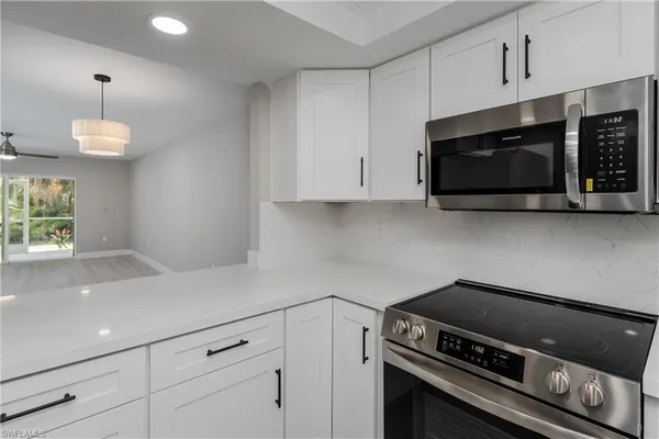 a kitchen with stainless steel appliances a stove a microwave and cabinets