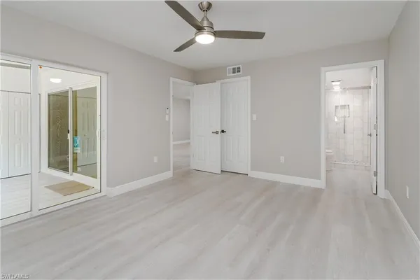 a view of an empty room with glass door