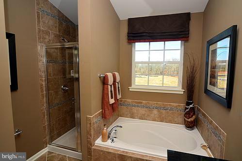 7332 Windsor Mill Road Baltimore, MD 21244 - Photo 3 of 19 a bathroom with a tub and a shower