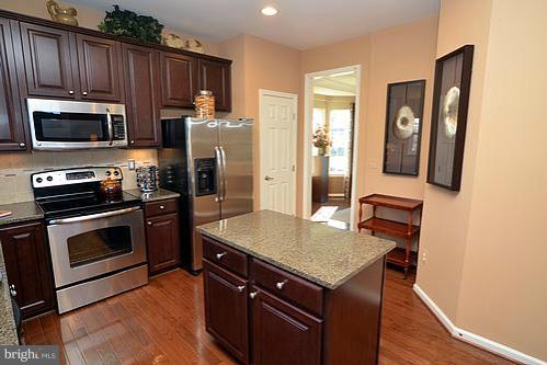 7332 Windsor Mill Road Baltimore, MD 21244 - Photo 6 of 19 a kitchen with stainless steel appliances granite countertop a stove refrigerator and microwave