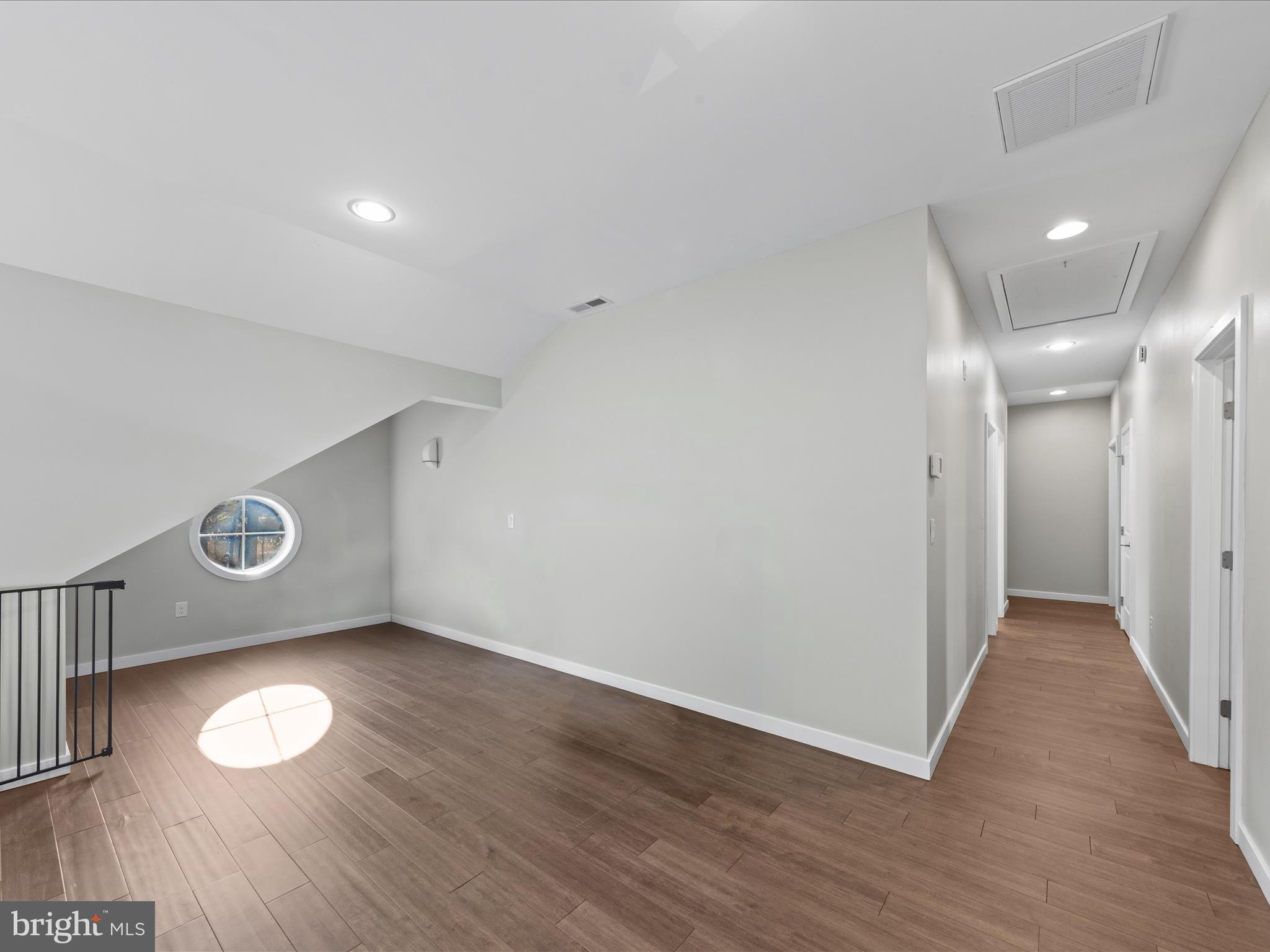 8475 New Hope Road Willards, MD 21874 - Photo 30 of 50 an empty room with wooden floor and windows