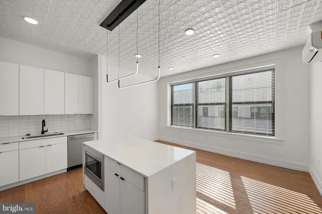 a kitchen with a refrigerator and a sink