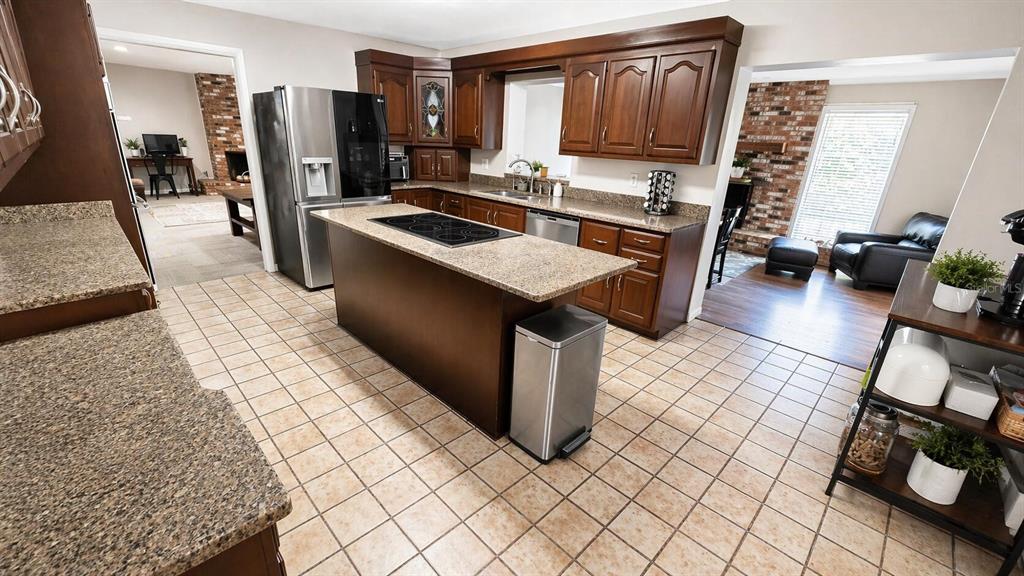 2313 Southeast 7th Street Ocala, FL 34471 - Photo 33 of 54 a kitchen with stainless steel appliances granite countertop a sink stove and refrigerator