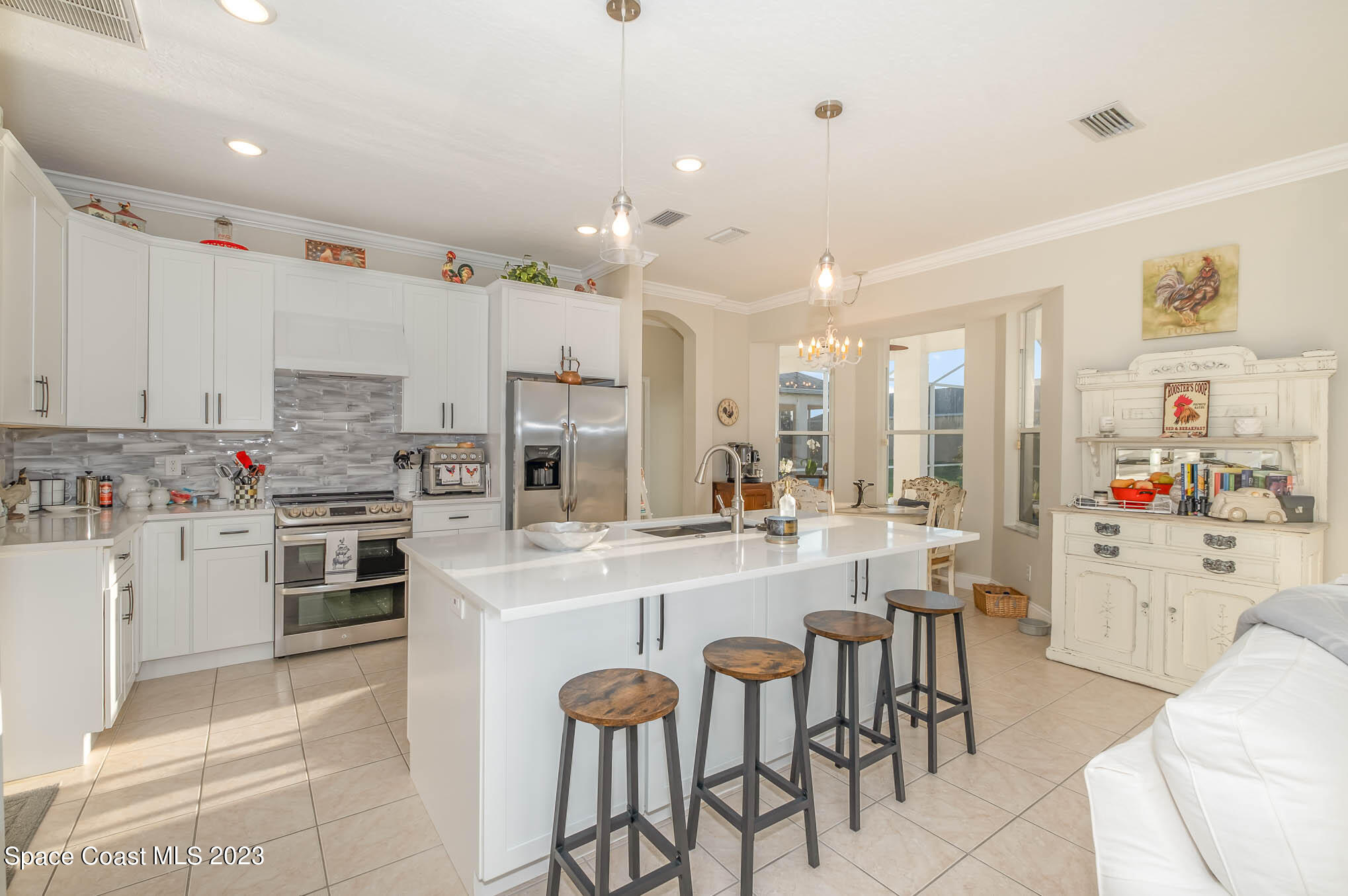 3032 Jacobaeus Lane Indialantic, FL 32903 - Photo 11 of 43 a kitchen with appliances a sink and cabinets