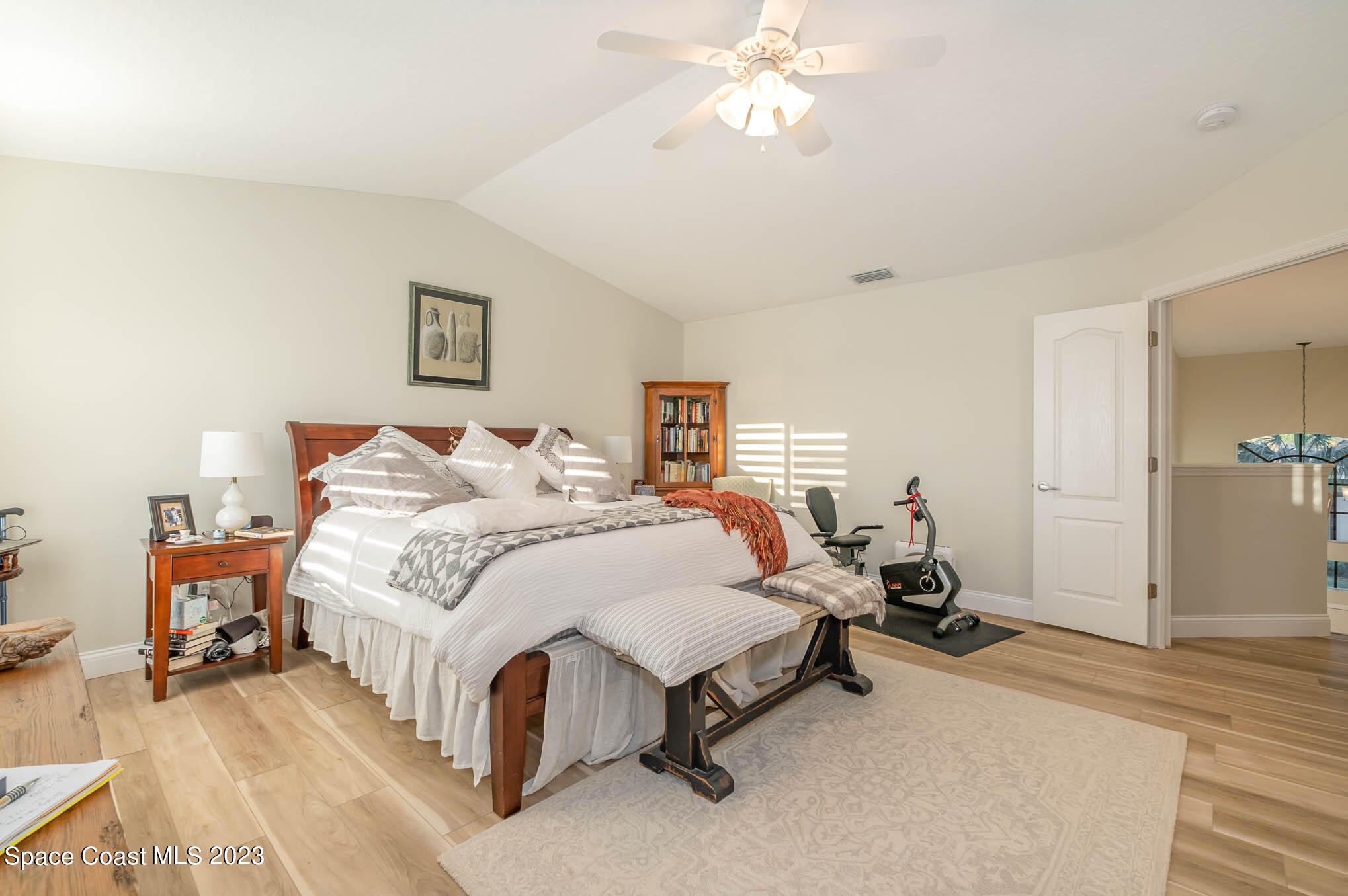 3032 Jacobaeus Lane Indialantic, FL 32903 - Photo 23 of 43 a spacious bedroom with a bed and a chandelier