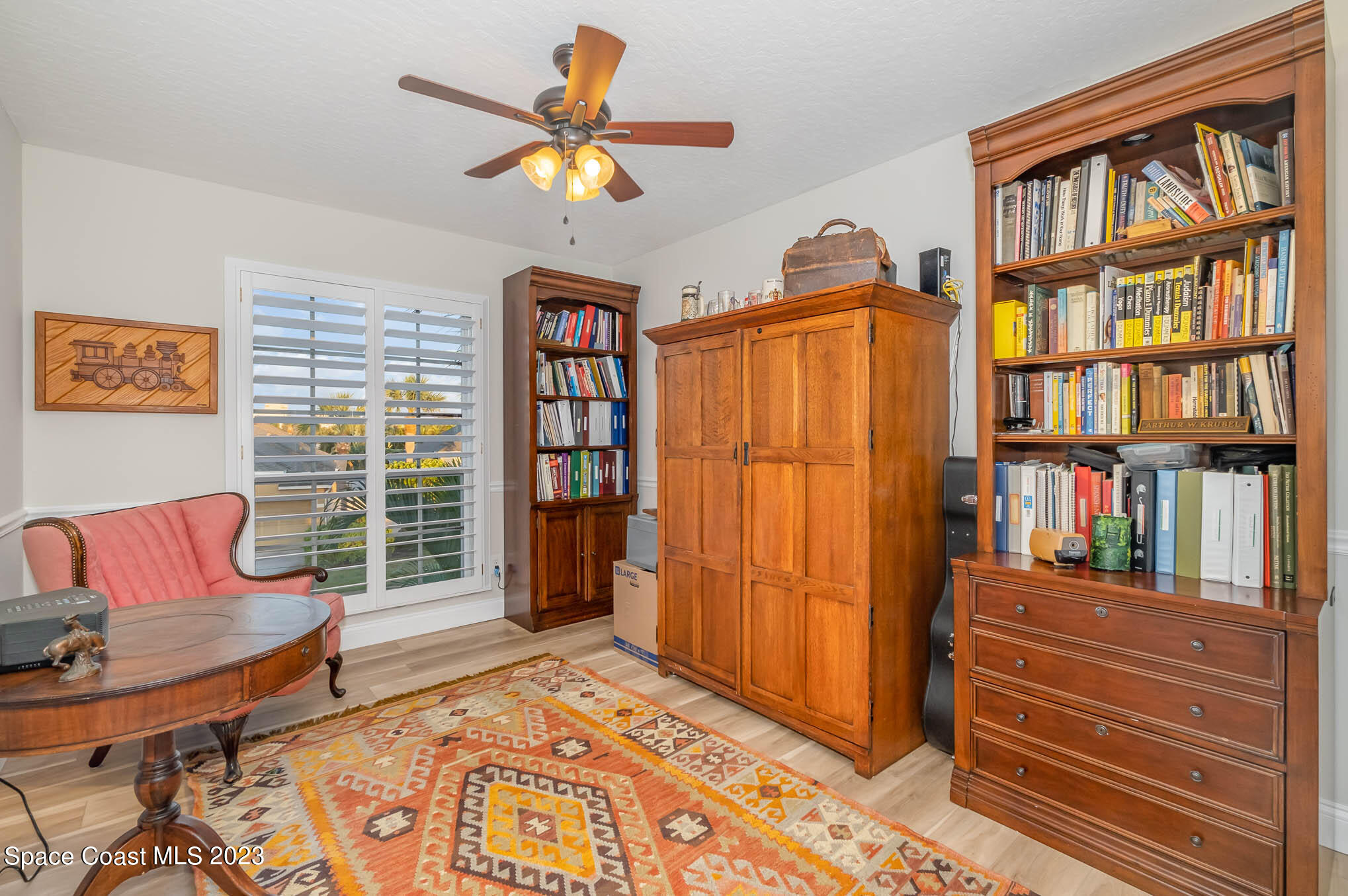 3032 Jacobaeus Lane Indialantic, FL 32903 - Photo 28 of 43 a living room with furniture a bookshelf and a window