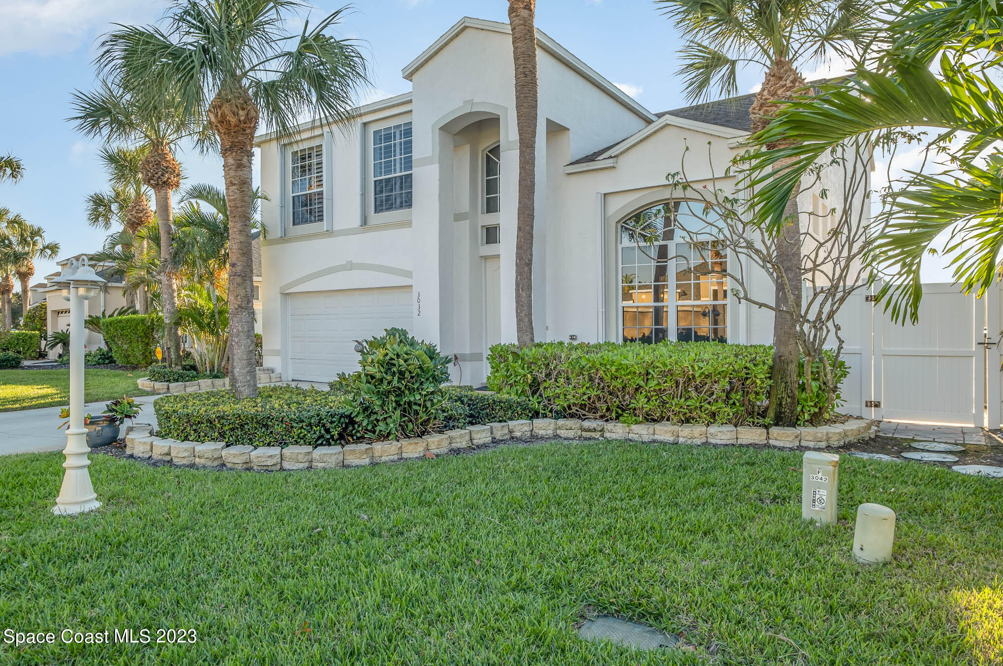 3032 Jacobaeus Lane Indialantic, FL 32903 - Photo 3 of 43 a front view of a house with a garden