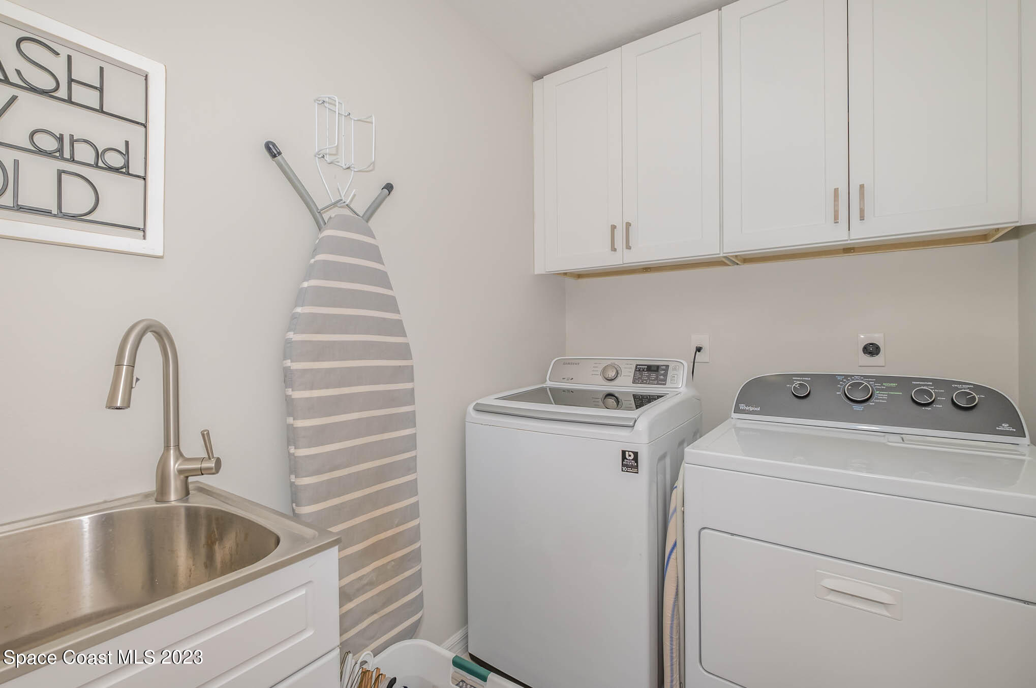 3032 Jacobaeus Lane Indialantic, FL 32903 - Photo 32 of 43 a view of storage and utility room with washer and dryer