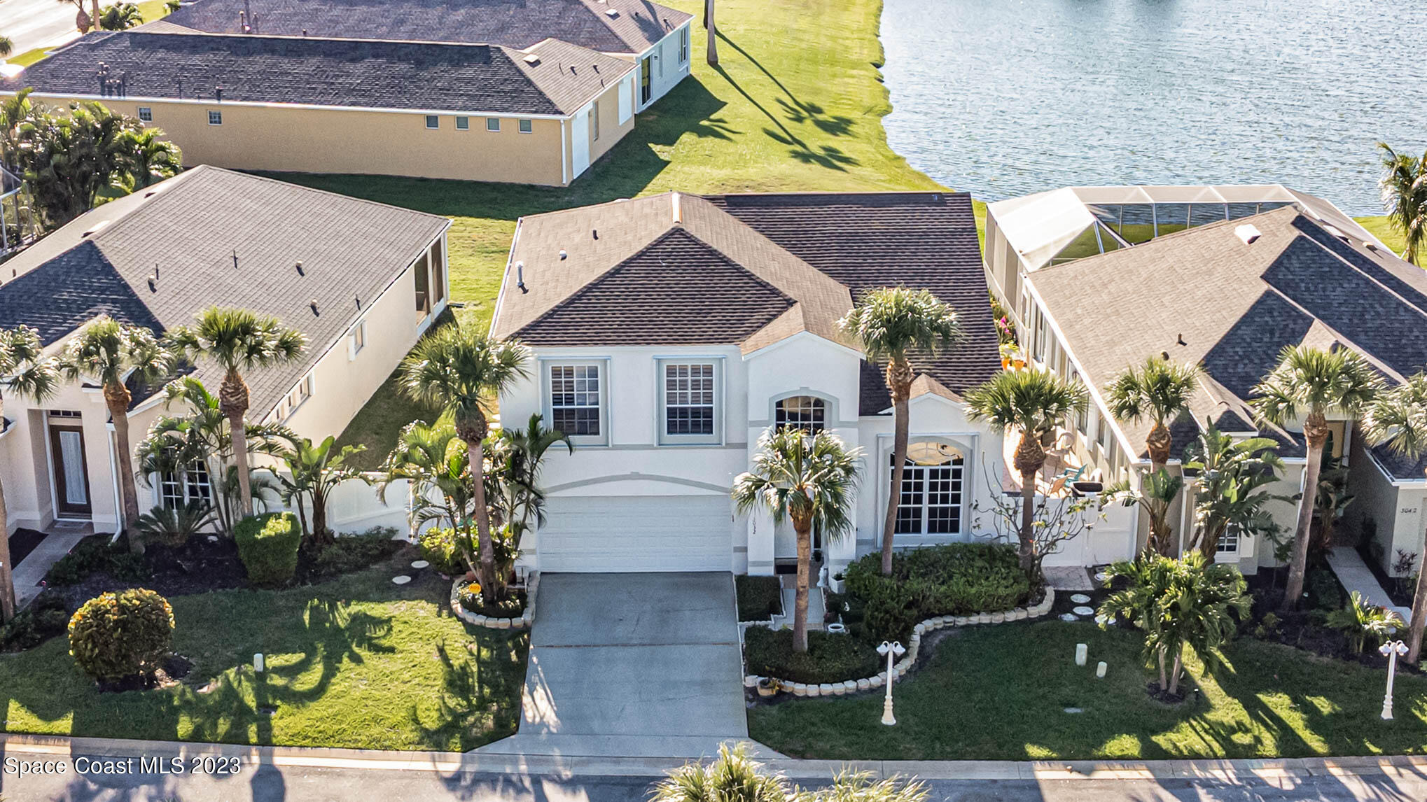 3032 Jacobaeus Lane Indialantic, FL 32903 - Photo 40 of 43 a front view of a house with a garden